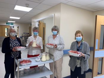 Friends serving strawberries to patients at Farnham Hospital